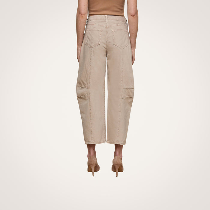 A person wearing the Cody Cropped Barrel-Leg Jean, featuring a beige wide-leg silhouette with patch pockets, paired with tan heels and shown from the back against a plain white background.