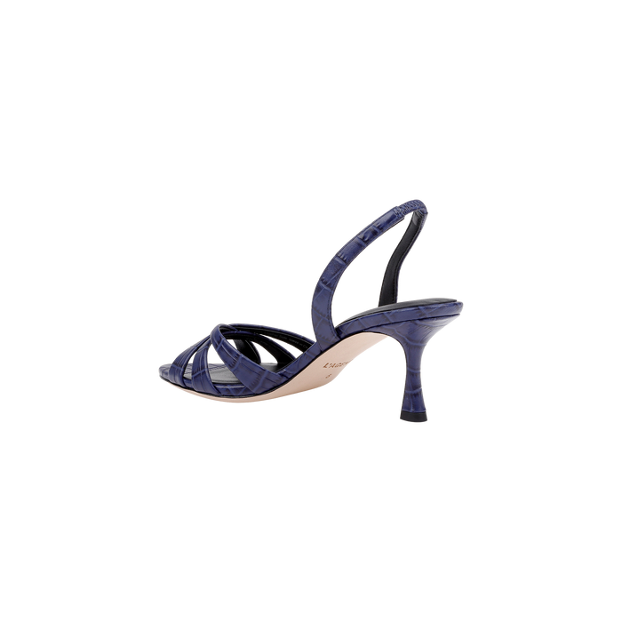 The Colwill Slingback Sandal is shown from the side on a plain white background, featuring a croc-embossed, dark blue textured finish with thin straps, an open toe design, and a mid heel.
