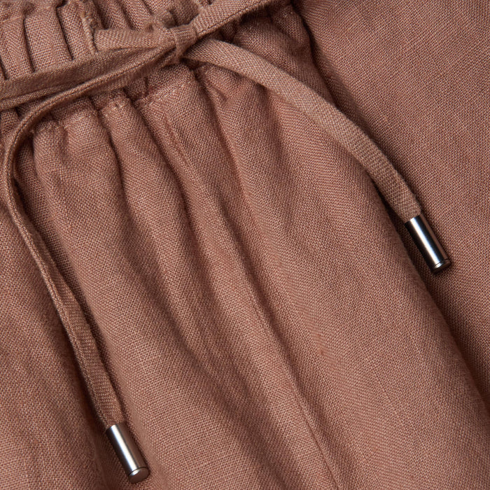 Close-up of the Connie Linen Drawstring Trouser in light brown, featuring a drawstring waistband with silver metal tips.