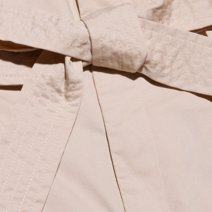 Close-up of a beige self-tie belt, part of the Damira Poplin Short, with visible stitching along the edges.