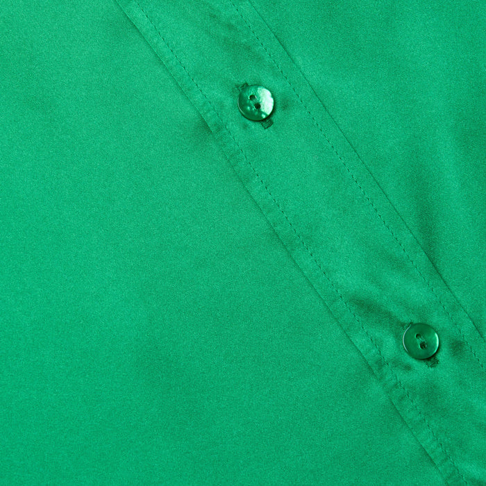 Close-up of a green Dani Silk Blouse highlighting two buttons and part of a seam, with smooth silk button-down fabric texture.