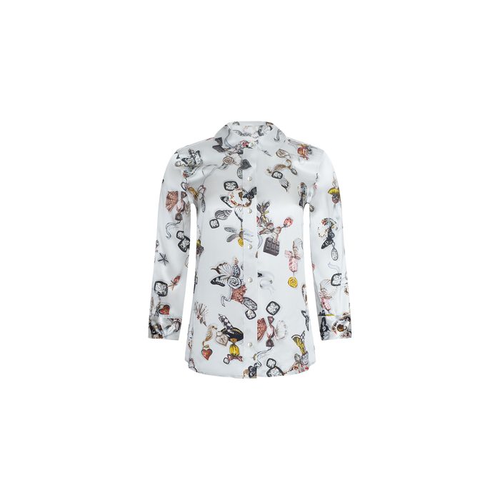 The Dani Silk Blouse is a white long-sleeve button-up shirt adorned with colorful cartoon-style illustrations, including animals, butterflies, and various objects scattered across the fabric. This butterfly print blouse is displayed on a plain white background.