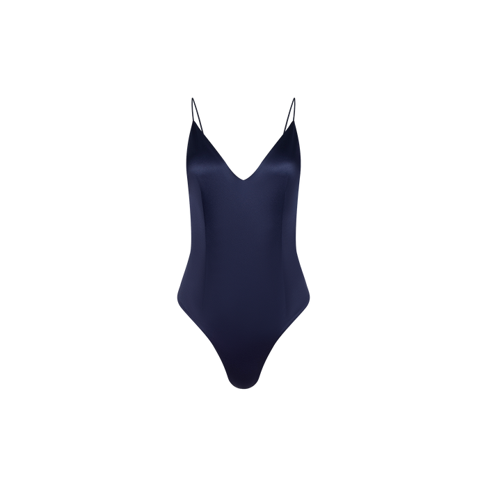 The Dara Stretch-Satin Bodysuit in dark blue features adjustable thin shoulder straps, a plunging neckline, and high-cut legs, shown against a plain white background.