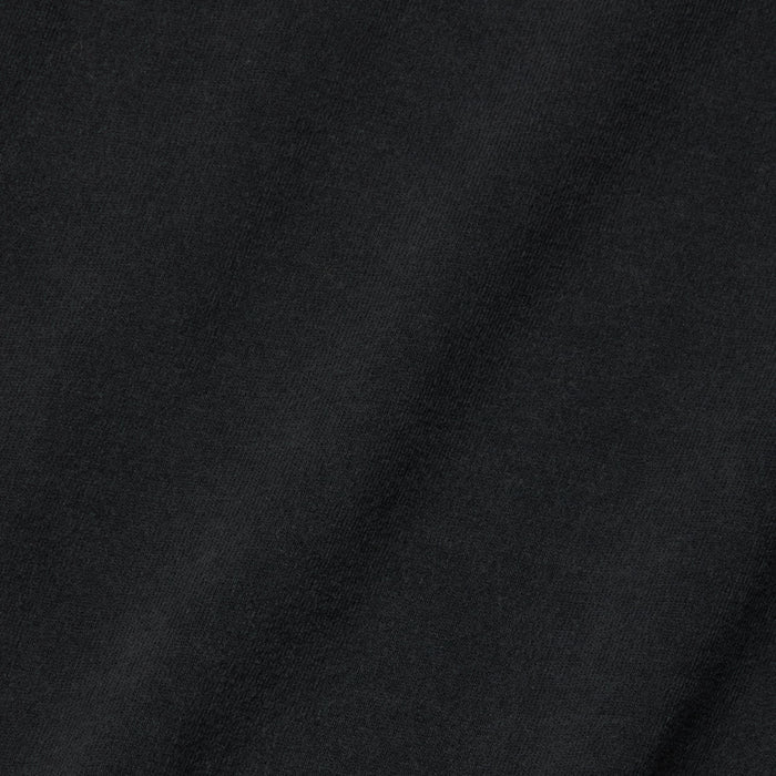 Close-up view of the Daria Oversized Cropped Tee in black, crafted from Supima cotton with a subtle diagonal weave pattern and a soft texture, accented by gentle shadows and highlights.