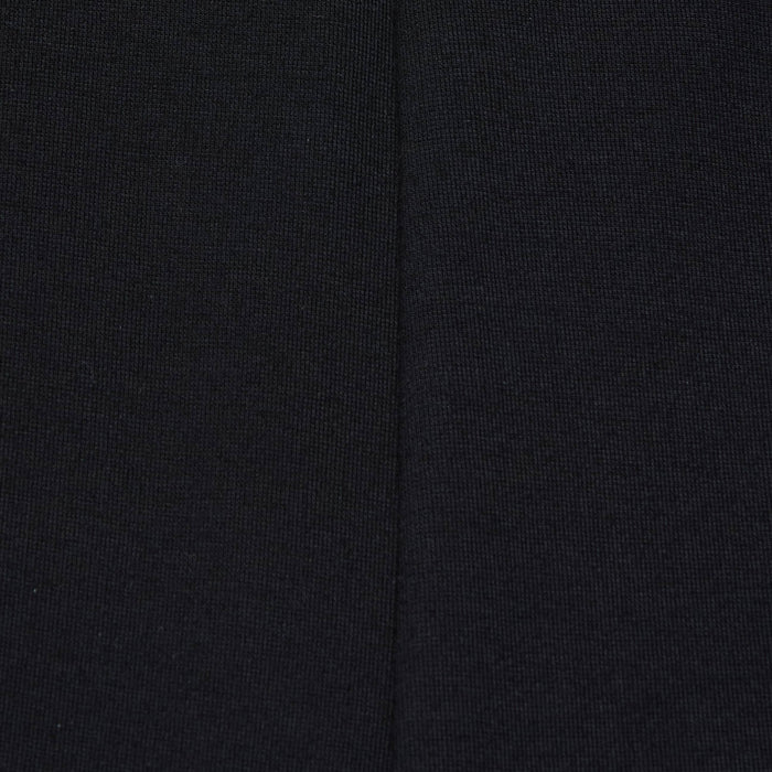 Close-up of the Dee Capri Pant in black stretch ponte fabric, highlighting a visible vertical seam down the center that showcases the material’s texture and stitching details for a flattering fit.