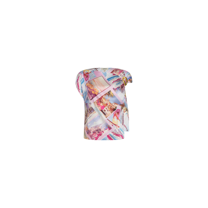 The Driselle Scarf Top is a short-sleeved, asymmetrical women’s top adorned with a pastel collage and postcard print featuring vintage-style images and text—perfect for vacation wear. Shown here on a plain white background.