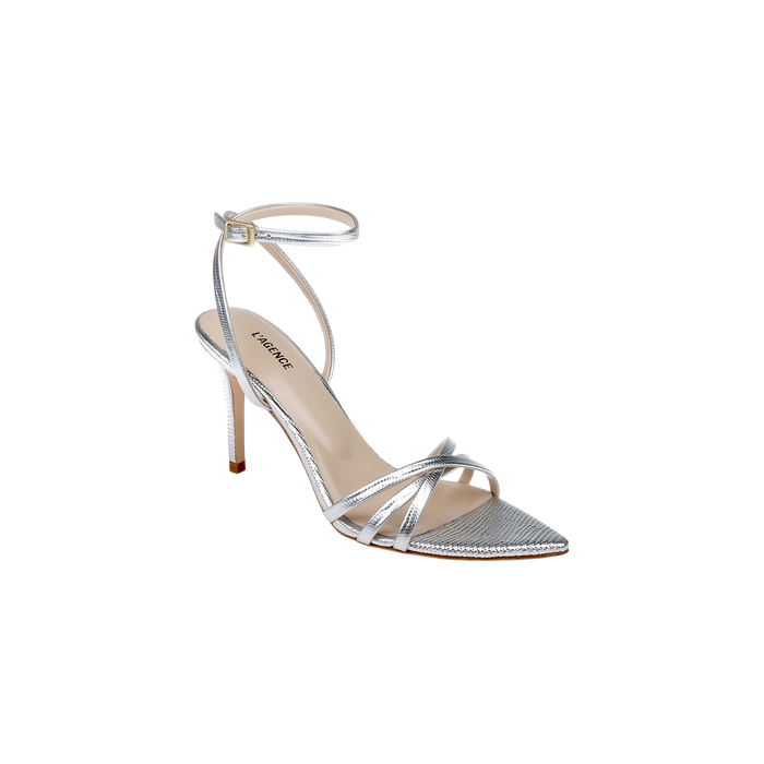 The Dua Leather Sandal is a silver lizard-embossed stiletto featuring thin ankle and toe straps, a pointed toe, and a buckle closure. This strappy heel includes a beige memory foam insole branded Nine West. The sandal is displayed against a plain white background.