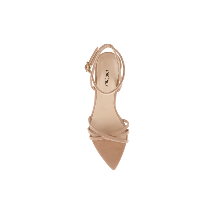 The Dua Suede Sandal, shown from above against a plain white background, is a single tan suede stiletto-heeled sandal featuring a strappy design, pointed toe, and secure ankle strap.