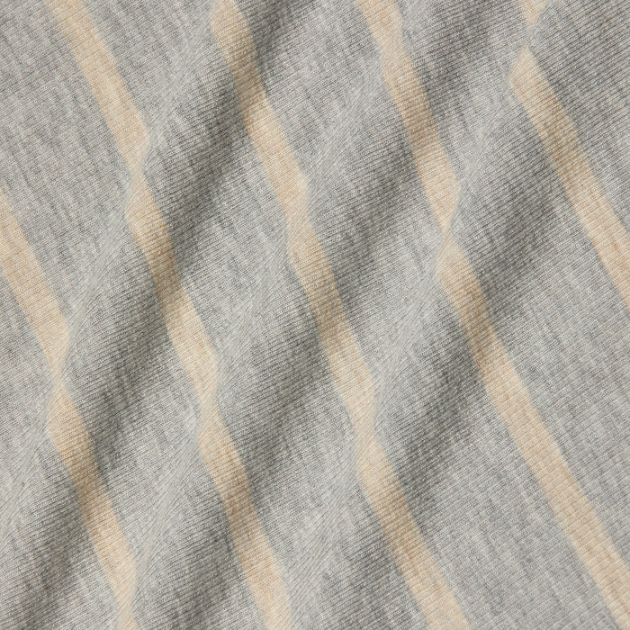 Ellis Tank Dress in gray fabric features beige diagonal stripes, showcasing a soft, textured surface with gentle folds and shadows. The stretch rib pattern adds a subtle, wavy appearance across the material.
