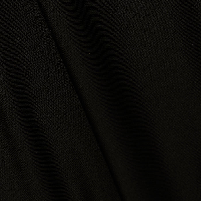 A close-up of the Emelia Bandeau One-Piece Swimsuit in black, highlighting its smooth texture, fine weave pattern, and four-way stretch nylon with a subtle diagonal fold in the fabric.
