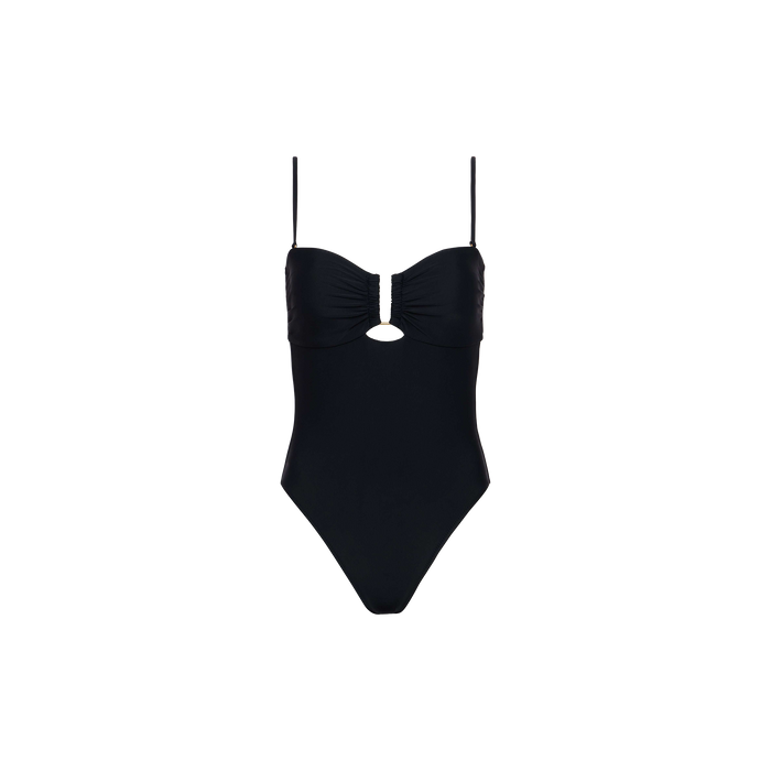 The Emelia Bandeau One-Piece Swimsuit is a black swimsuit designed with thin shoulder straps, a ruched bust, and a small keyhole cutout below the bust. Made from four-way stretch nylon for optimal comfort and flexibility, this one-piece features a flattering high-leg cut and is displayed on a plain white background.