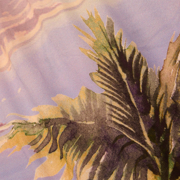 Abstract painting of green palm leaves against a pastel purple and peach background, reminiscent of a tropical landscape with soft, flowing brushstrokes. This composition echoes the carefree spirit of the Enyo Cover-Up Short, featuring a relaxed pull-on silhouette and postcard print-inspired colors.