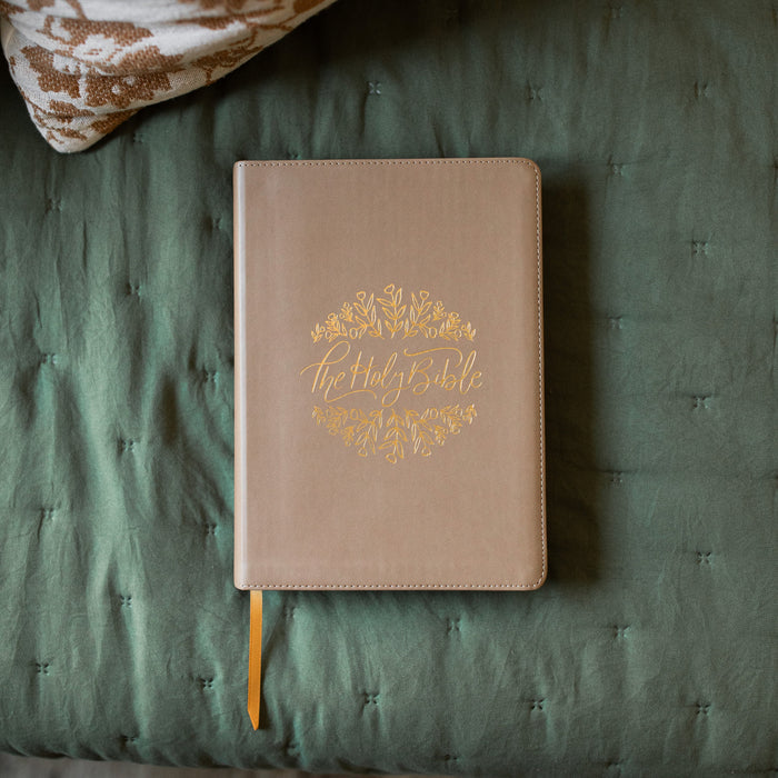 ESV Journaling Bible with gold etching on a green blanket