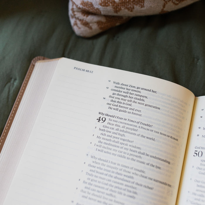 ESV Journaling Bible up close and opened to Psalms on a green blanket