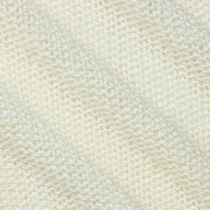 Close-up of the textured, cream-colored fabric of the Ethan Knit Pullover, featuring a diagonal ribbed pattern that highlights the fine stitches and softness of this knit garment.