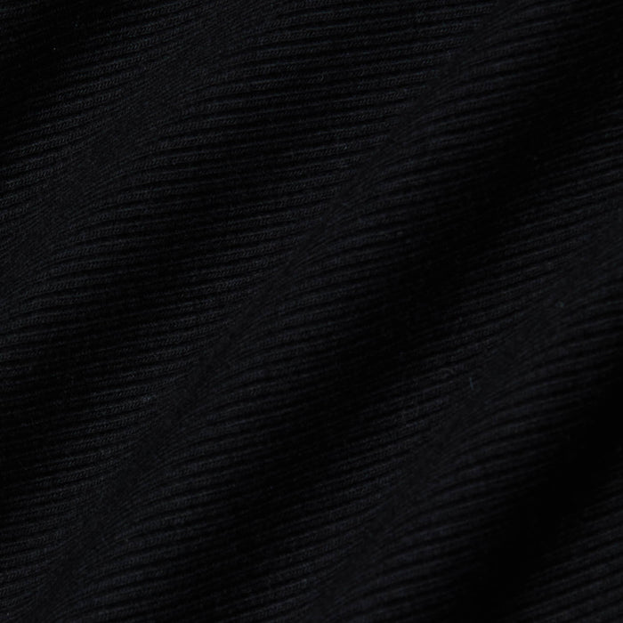 Close-up of the black ribbed fabric from the Evelyn Off-The-Shoulder Bodysuit, showcasing horizontal textured lines and gentle folds that cast subtle shadows and add depth to the stretch cotton modal material.