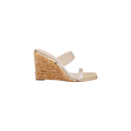 The Farrell Wedge Espadrille is a raffia wedge sandal with a woven straw heel and two clear vamp straps across the foot, shown in side profile on a white background. This stylish design is completed with a modern square toe.