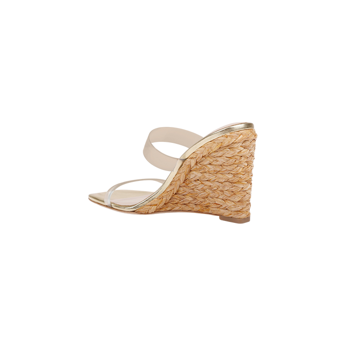 The Farrell Wedge Espadrille is shown in a side view against a plain white background, featuring beige coloring, clear straps, a braided raffia wedge heel, and a square toe.