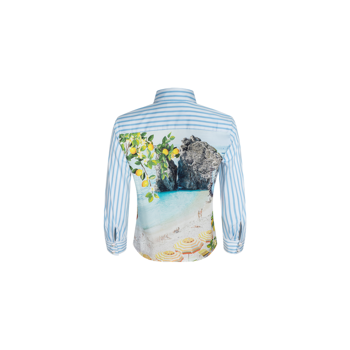The Fawn Beach Print Shirt is a blue and white striped shirt made from organic cotton, showcasing a scenic beach, lemon tree, and rock formation print on the back.