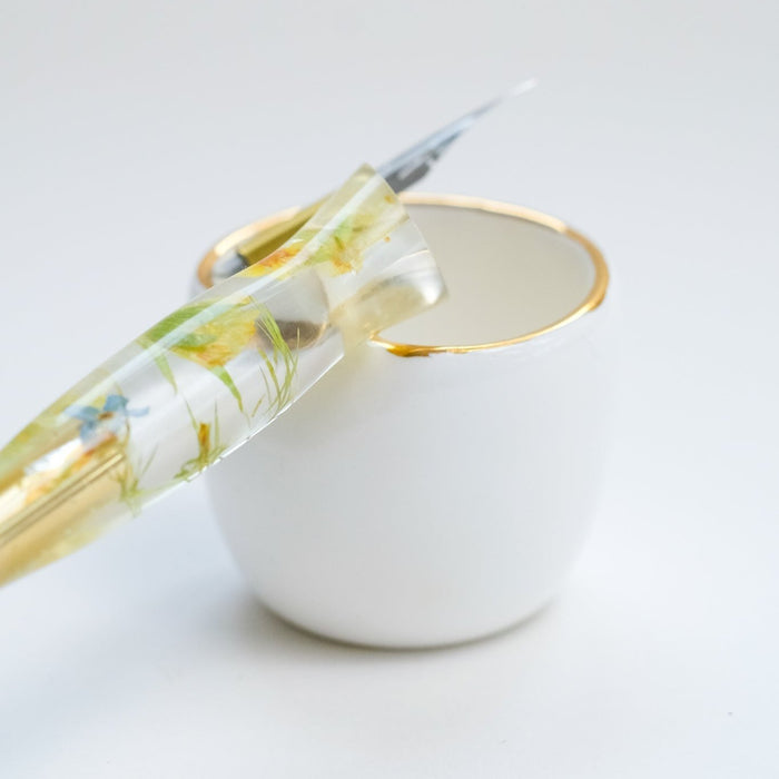 Fine Bone China Artist's Ink Well by Wendy Tournay with a calligraphy pen resting on it