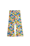 A pair of wide-leg pants featuring a colorful retro floral print with blue, pink, yellow, and orange flowers on a white background with green leaves.