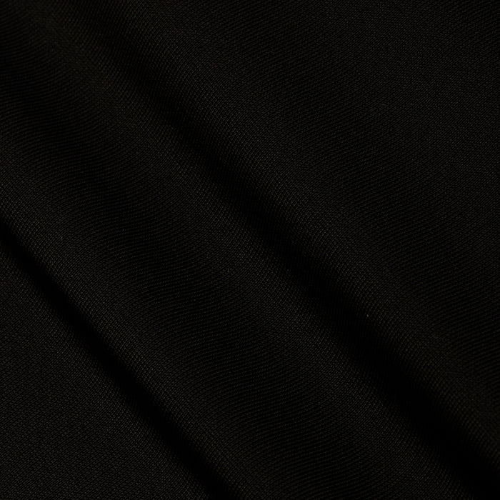A close-up of black fabric from the Gabrielle One-Piece Swimsuit, featuring subtle diagonal folds and a fine, textured weave that evokes minimalist elegance.
