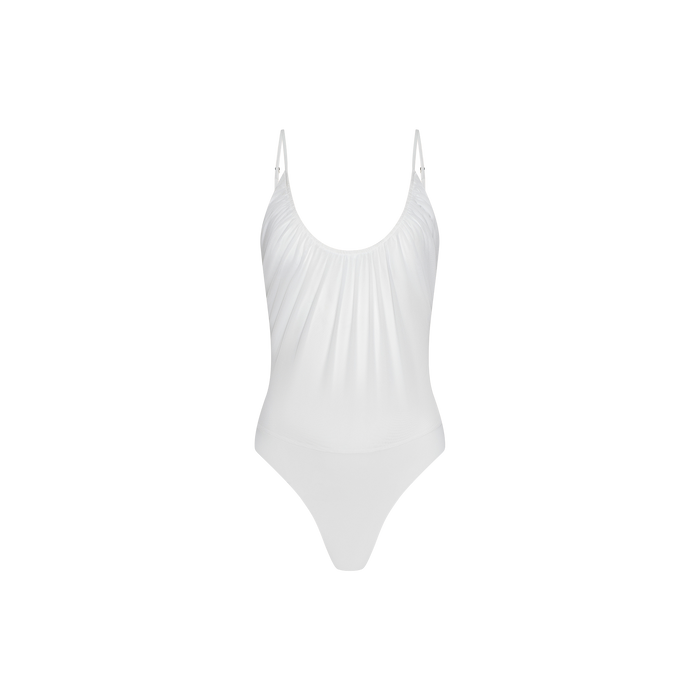 The Gelina Mesh Bodysuit is a white one-piece featuring lightweight mesh, thin adjustable straps, and a slightly ruched gathered front detail, shown against a plain white background.