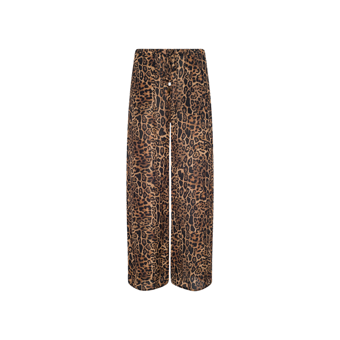 The Geraldine Cover-Up Pant showcases a bold brown and black leopard print in a wide-leg silhouette, designed with a comfortable pull-on fit and displayed against a crisp white background—ideal for resort wear.
