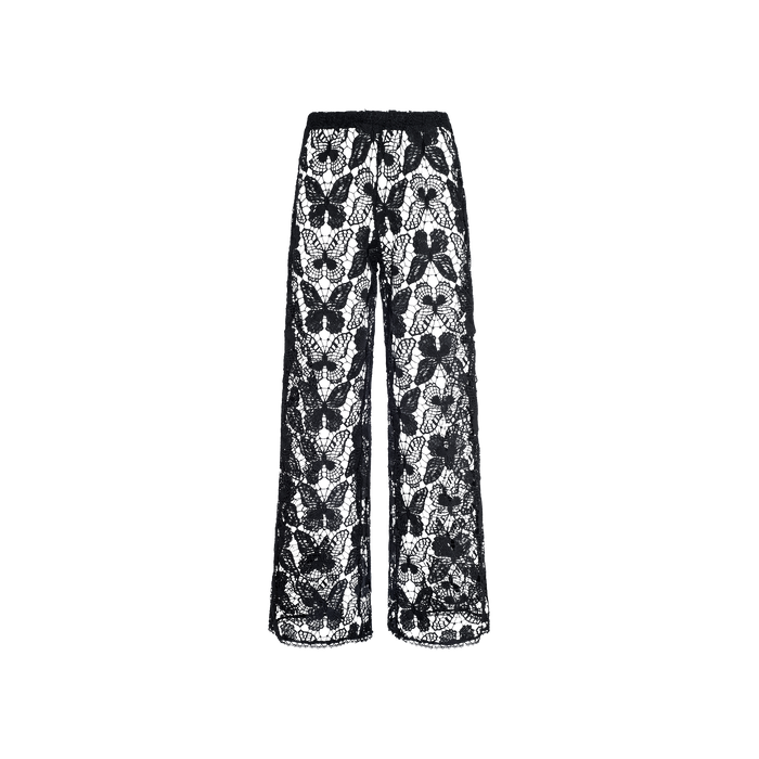 The Geraldine Cover-Up Pant showcases a relaxed bohemian vibe with its black, wide-leg design crafted entirely from sheer floral lace. Featuring a high waist and loose fit, these resort-ready pants are displayed against a plain white background.