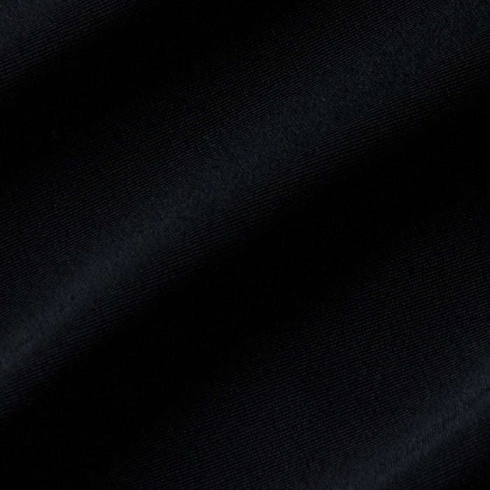 Close-up of black fabric with visible diagonal ribbing and gentle folds, highlighting the texture and subtle sheen—ideal for the Gianna Brazilian Bikini Bottom with its mid-rise fit and cheeky cut.
