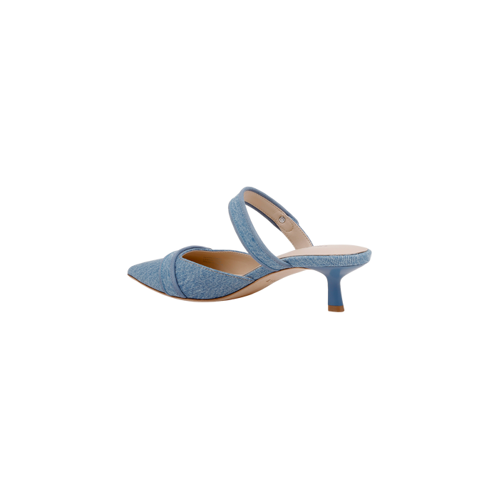 Gilliane Denim Mule in light blue features a pointed toe, crisscross strap across the front, memory foam insole, and a mid-height stiletto heel, shown on a white background.