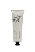 Hand cream tube with floral design and text on a white background