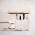 Leather Pen Roll handmade by Edward de Lacy with a selection of pens stored inside the pockets