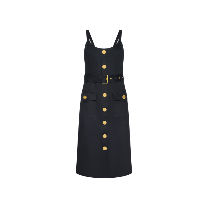 The Ida Dress is a sleeveless black stretch cotton dress featuring shoulder straps, gold buttons down the front, two large front pockets adorned with gold buttons, and a matching belt with a gold buckle, displayed on a plain white background.