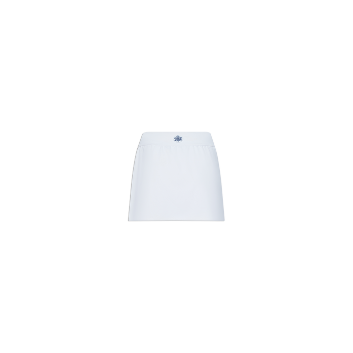 Iga Tennis Skort with a mini straight cut, crafted from performance fabric and finished with a small blue embroidered logo at the center waistband. Displayed on a plain white background.