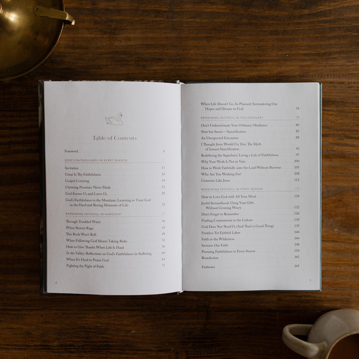 In the Grips of His Grace Study opened to Page 4 about the Table of Contents, on a brown wooden table next to a bronze oil lamp and a white coffee cup
