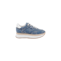 The Ivone Platform Sneaker is shown in side profile on a plain white background, featuring a blue denim upper, white laces, a thick white platform sole, brown trim, and white accents on the heel and tongue.