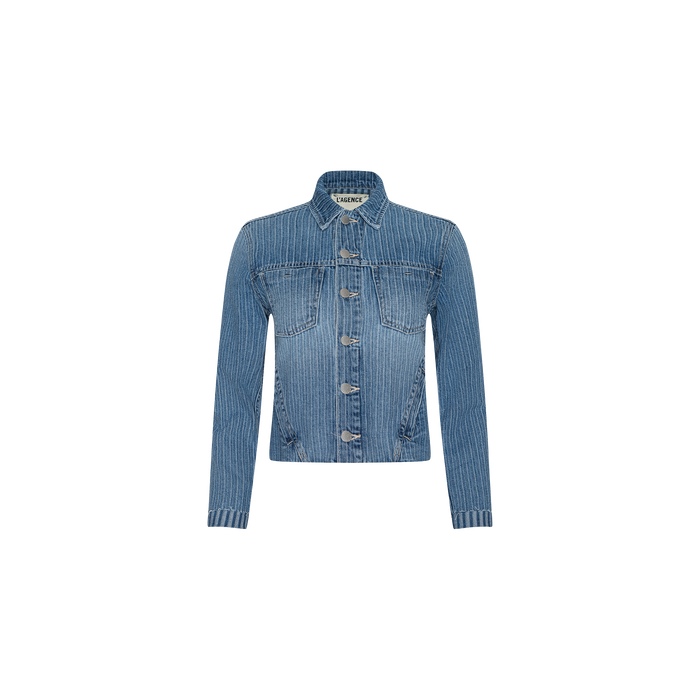 The Janelle Jean Jacket, an all-cotton denim piece in blue with a collar, front button closure, and vertical white pinstripes, is displayed against a plain white background. This slim fit jacket offers a modern take on classic style.