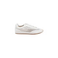 Introducing the Jarah Sneaker: This retro-inspired shoe showcases a white leather upper with mesh side detailing and a brown sole, displayed in profile against a plain white background. Its design is finished with a plush memory foam insole, ensuring lasting comfort.
