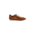 Introducing the Jarah Sneaker: a brown suede sneaker with white laces and a white sole, featuring a mesh side panel design and a comfortable memory foam insole. Shown in a side view against a plain white background.
