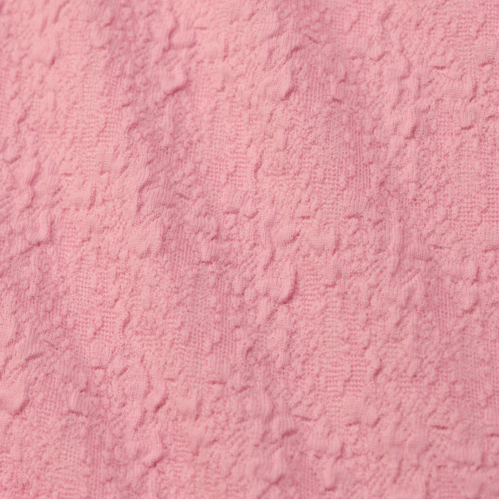 Close-up of the Jean Bikini Bottom, crafted from textured bouclé fabric featuring a slightly rough, uneven surface with subtle raised patterns.