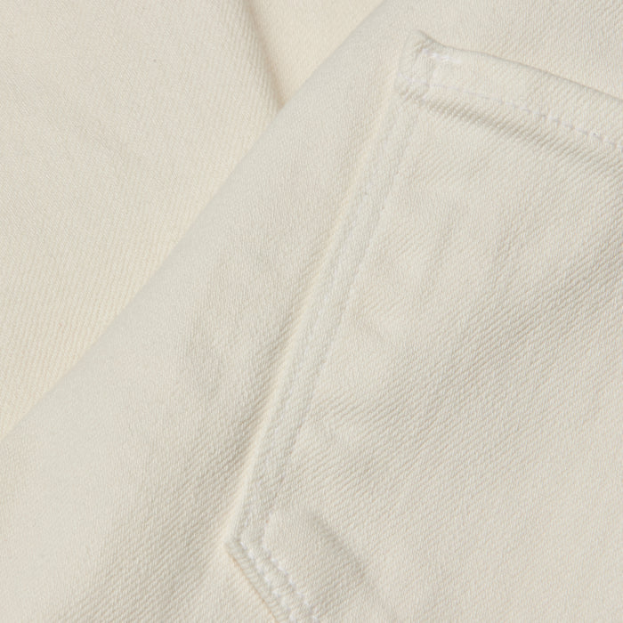 Close-up of a cream-colored fabric with a visible pocket seam and diagonal twill texture, likely part of the Joanne Low-Rise Wide-Leg Jean in an ecru wash.