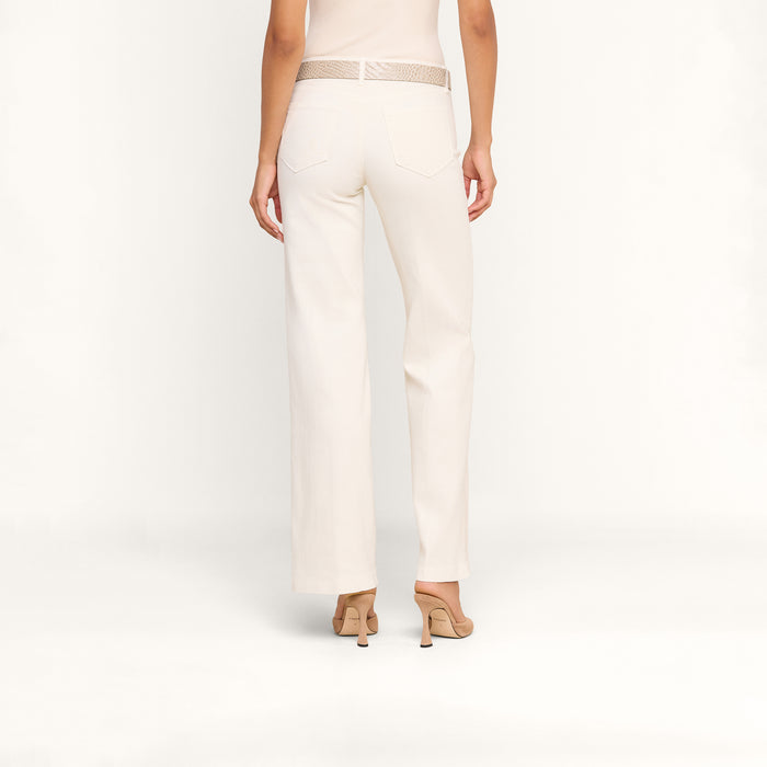 A person is shown from the back against a plain white background, wearing Joanne Low-Rise Wide-Leg Jeans in an ecru wash, styled with a matching belt and beige heeled sandals.