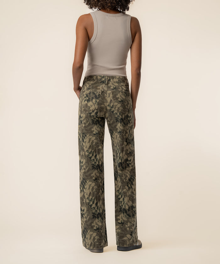 Olive floral print high-rise wide straight leg jeans with zip fly, shown from back on model wearing beige tank top.