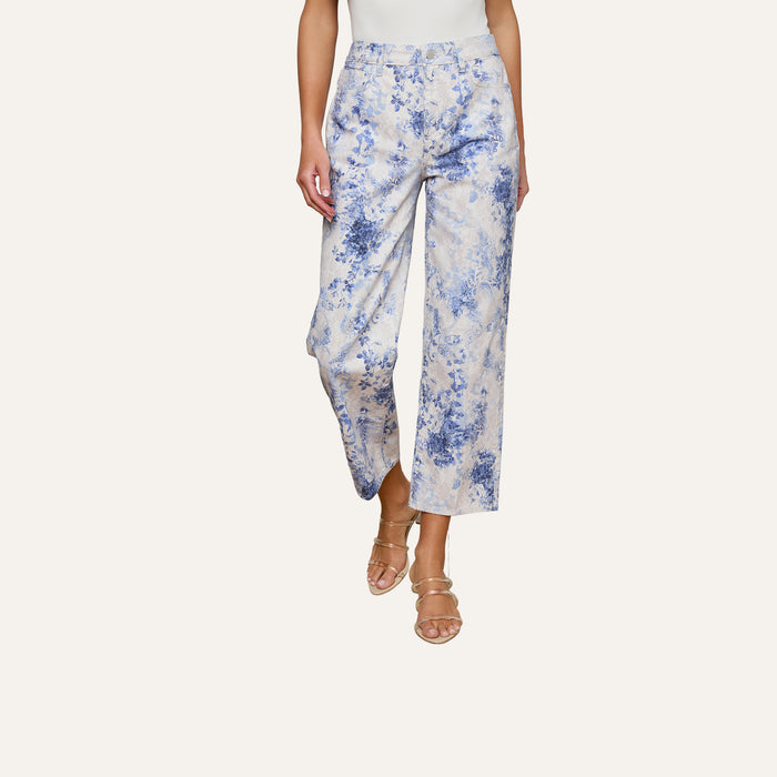 A person wears the June Cropped Stovepipe Jean along with a white top and beige strappy sandals, standing against a plain background.