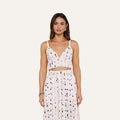 Woman wearing the Kaori Bralette Top, a white sleeveless bralette paired with a matching high-waisted skirt featuring a colorful lipstick print, standing against a plain light background.
