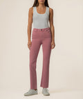 Woman wearing rose pink high-rise ankle flare jeans with a gray sleeveless tank top.