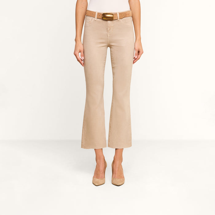 A person is shown from the waist down, facing forward against a plain white background, wearing the Kendra Coated Cropped Flare Jean with a matching belt and beige heels.