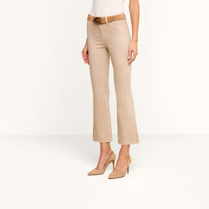 Woman wearing Kendra Coated Cropped Flare Jean in a high rise beige style, paired with a brown belt and beige high heels, standing against a plain white background. Upper body is partially out of frame.