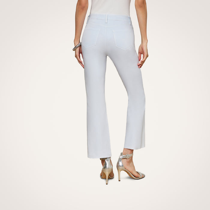 A person wearing the Kendra Coated Cropped Flare Jean in light blue and silver high heels, shown from the back against a plain white background.